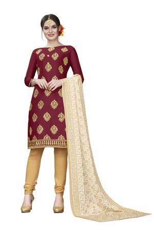 This Festive Season, Adorn A Rich, Simple And Elegant Look With This Dress Material In Maroon Colored Top Paired With Beige Colored Bottom And Cream Colored Dupatta. This Dress Material Is Cotton Based Beautified With Jari Embroidered Butti. Get This Stitched As Per Your Desired Fit And Comfort. 