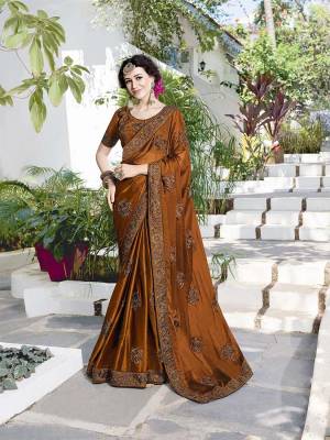 Enhance Your Personality Wearing This Heavy Designer Saree In Brown Color Paired With Brown Colored Blouse. This Saree Is Fabricated On Satin Chiffon Paired With Art Silk Fabricated Blouse. This pretty Saree Is Durable, Light Weight And Easy To Carry All Day Long. 