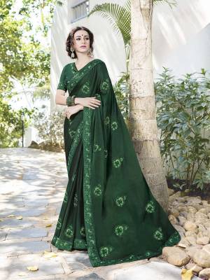 Celebrate This Festive Season With Beauty And Comfort Wearing This Heavy designer Saree In Dark Green color Paired With Dark Green Colored Blouse. This Saree Is Fabricated on Satin Chiffon Paired With Art Silk Fabricated Blouse. It Is Light Weight And Its Fabric Ensures Superb Comfort All Day Long. 