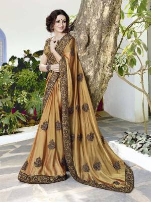 Simple And Elegant Looking Heavy Designer Saree IS Here In Beige color Paired With beige Colored Blouse, this Saree Is Satin Chiffon Based Paired With Art Silk Fabricated Blouse. It Has Embroidered Lace Border With Butti All Over. 