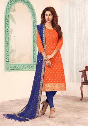 Bright And Visually Appealing Color Pallete Is Here With This Dress Material In Orange Colored Top paired With Contrasting Blue Colored Bottom And Dupatta. Its Top Is Fabricated On Art Silk Paired With Cotton Bottom And Banarasi Jacquard Dupatta. Its Top And Dupatta Are Beautified With Weave. buy This Dress Material now.