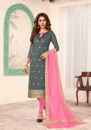 Shine Bright Wearing This Designer Dress Material In Grey Colored Top Paired With Contrasting Pink Colored Bottom And Dupatta. Its Top Is Silk Based Paired With Cotton Bottom And Banarasi Jacquard Dupatta. 