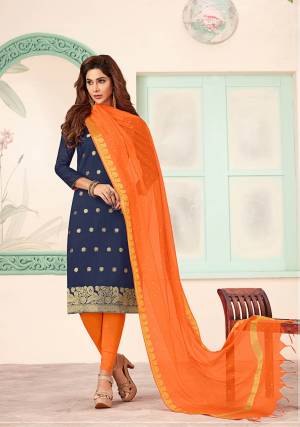 Shine Bright Wearing This Designer Dress Material In Navy Blue Colored Top Paired With Contrasting Orange Colored Bottom And Dupatta. Its Top Is Silk Based Paired With Cotton Bottom And Banarasi Jacquard Dupatta. 