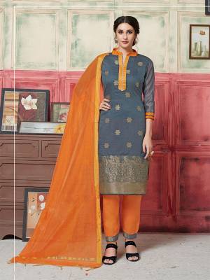 Simple Dress Material Is Here For Your Semi-Casual wear In Grey Colored Top Paired With Contrasting Orange Colored Bottom And Dupatta. This Silk Based Dress Material Is Beautified With Weave. Buy Now.