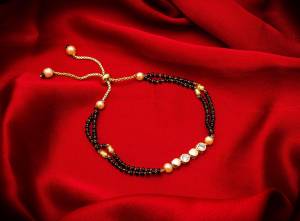 Here Is Very Pretty And Trending Mangalsutra Bracelet In Black And Gold. This Mangalsutra Bracelet Has A Pretty Delicate Design And Pattern Which Gives An Elegant Look To Your Wrist. Buy This Latest Trend Now.