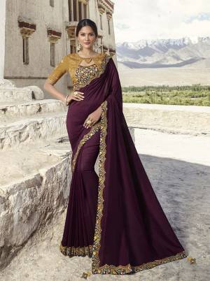 Rich And Elegant Looking Heavy Designer Saree Is Here In Wine Color Paired With Beige Colored Blouse. This Silk Based Saree And Blouse Are Beautified With Subtle And Attractive Embroidery Which Gives An Enhanced Look To Your Personality. 