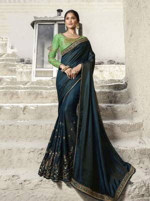 New Shade Is Here To Add Into Your Wardrobe With This Heavy Designer Saree In Prussian Blue Color Paired With Contrasting Parrot Green Colored Blouse. This Saree And Blouse are Silk Based Which also Gives A Rich Look To Your Personality. Buy This Saree Now.