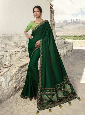 Go With The Pretty Shades Of Green With This Heavy Designer Saree In Dark Green Color Paired with Light Green Colored Blouse. This Saree Is Fabricated on Soft Silk Paired With art Silk Fabricated Blouse. It Is Light Weight And Easy To Carry All Day Long. 