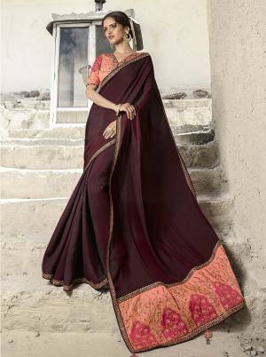 For A Royal Look, Grab This Designer Saree With Rich Color Pallete In Maroon Colored Saree Paired With Contrasting Peach Colored Blouse. This Saree Is Fabricated on Soft Silk Paired With Art Silk Fabricated Blouse. Its Rich Color And Fabric Will Ean You Lots Of Compliments From Onlookers. 