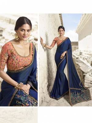 You Will Definitely Earn Lots Of Compliments Wearing This Heavy Designer Saree In Royal Blue Color Paired With Contrasting Dark Peach Colored Blouse. This Saree And Blouse Are Silk Based Beautified With Heavy Embroidery All over. Buy Now.