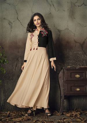 Simple and Elegant Looking Designer Readymade Gown Is Here In Peach And Black Color Fabricated On Rayon. It Is Beautified With Attractive Thread Work Over The Yoke. Buy Now.