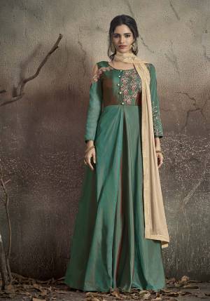 Two Tone Shades Silk IS Here With This Readymade Designer Floor Length Suit In Peacock Blue Colored Top And Bottom Paired With Beige Colored Dupatta. Its Top Is Fabricated On Tafeta Art Silk Paired With Santoon Bottom And Chiffon Fabricated Dupatta. 