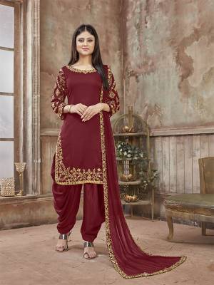 Get Ready For The Upcoming Festive And Wedding Season With This Designer Suit In Maroon Color Paired With Maroon Colored Bottom And Dupatta. Its Top Is Fabricated On Art Silk Paired With Santoon Bottom And Net Fabricated Dupatta. It Is Beautified With Heavy Jari Embroidery And Mirror Work. Buy Now.