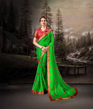 Bright And Appealing Color Is Here With This Saree In Parrot Green Color Paired With Contrasting Red Colored Blouse. This Saree Is Chiffon Based Paired With Art Silk Fabricated Blouse. It Is Light In Weight And Easy To Carry All Day Long. 