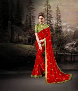 Bright And Appealing Color Is Here With This Saree In Red Color Paired With Contrasting Green Colored Blouse. This Saree Is Chiffon Based Paired With Art Silk Fabricated Blouse. It Is Light In Weight And Easy To Carry All Day Long. 