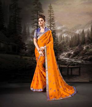 Rich And Elegant Looking Saree Is Here In Orange Color Paired With Contrasting Violet Colored Blouse. This Saree Is Fabricated On Chiffon Paired With Art Silk Fabricated Blouse. Its Fabric Is Light Weight, Durable And Easy To Carry All Day Long. 