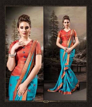 Shine Bright In This Very Pretty Designer Saree In Blue Color Paired With Contrasting Red Colored Blouse. This Saree Is Fabricated On Chiffon Beautified With Prints Paired With Art Silk Fabricated Weaved Blouse. Buy This Saree Now.
