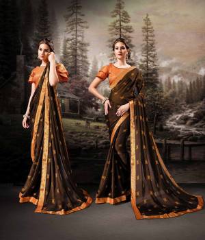 For A Royal And Beautiful Look, Grab This Designer Saree In Dark Brown Color Paired With Contrasting Orange Colored Blouse. This Saree Is Fabricated On Chiffon Paired With Art Silk Fabricated Blouse. Its Pretty Color Pallete And Fabric Will Earn You Lots Of Compliments From onlookers. 