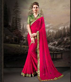 Rich And Elegant Looking Saree Is Here In Rani Pink Color Paired With Contrasting Dark Green Colored Blouse. This Saree Is Fabricated On Chiffon Paired With Art Silk Fabricated Blouse. Its Fabric Is Light Weight, Durable And Easy To Carry All Day Long. 