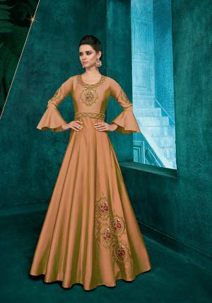 Simple And Elegant Looking Designer Readymade Gown Is Here In Beige Color Fabricated On Soft Art Silk Beautified With Attractive Embroidery Over The Yoke And Panel. 