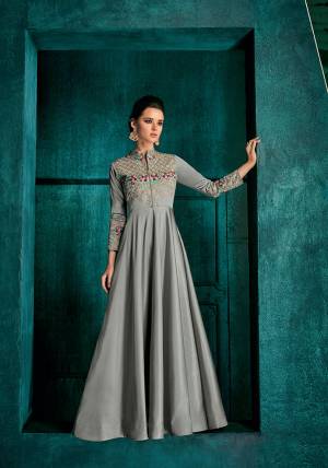 Flaunt Your Rich And Elegant taste In This Very Pretty Designer Readymade Gown In Grey Color Fabricated On Soft Art Silk Beautified With Attractive Embroidery With Jari And Contrasting Threads. Buy Now.