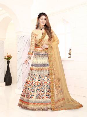 Simple And Elegant Looking Designer Lehenga Choli Is Here In Cream Color Paired With Beige Colored Dupatta. This Lehenga Choli Is Silk Based Beautified With Digital Prints And Stone Work, Paired With A Very Pretty Net Fabricated Dupatta. 