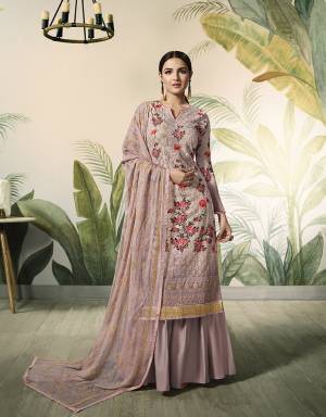 Flaunt Your Rich and Elegant Taste With This Subtle Colored Designer Lakhnavi Suit In Dusty Pink Color. Its Top Is Georgette Based Beautified With Prints And Embroidery Paired With Santoon Bottom And Embroidered Chiffon Fabricated Dupatta. 