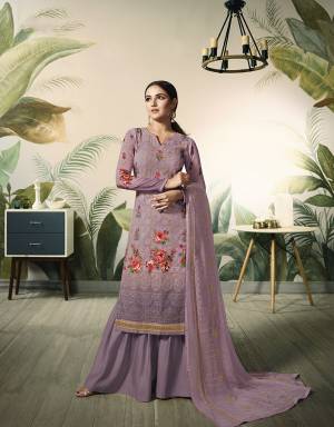 New And Unique Shade Is Here To Add Into Your Wardrobe With This Heavy Designer Straight Suit In Shade Of Purple That Is Mauve Color. This Lakhnavi Top Is Fabricated On Georgette Paired With Santoon Bottom And Chiffon Fabricated Dupatta. Its Heavy Top And Dupatta Will Earn You Lots Of Compliments From Onlookers. 