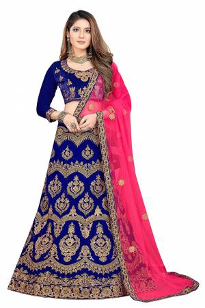 Bright And Visually Appealing Color IS Here For A Bridal Wear With This Heavy Designer Lehenga Choli In Royal Blue Color Paired With Contrasting Fuschia Pink Colored Dupatta. This Heavy Embroidered  Lehenga Choli Is Velvet Based Paired With Net Fabricated Dupatta. 