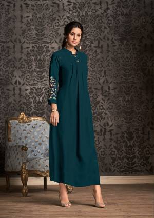 Lovely Shade Is Here With This Designer Readymade Long Kurti In Prussian Blue Color Fabricated On Rayon. It Is Beautified with Thread Work Over The Sleeves With Multi Color.  It Is Light Weight And Easy To Carry All Day Long. 