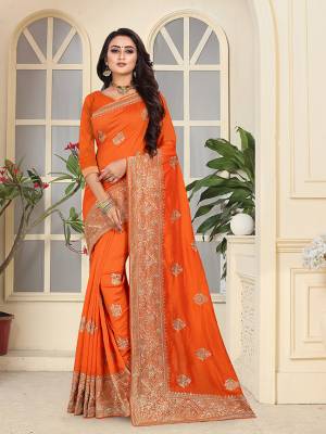 Celebrate This Festive Season With A Proper Traditional Touch Wearing This Heavy Designer Saree In Orange Color. This Saree And Blouse Are Fabricated On Soft Art Silk Beautified With Heavy Jari Embroidery And Stone Work. 