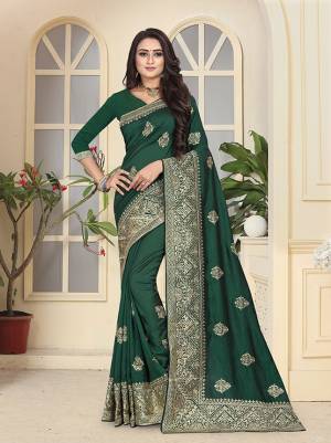 Get Ready For The Upcoming Festive And Wedding Season With This Heavy Designer Saree In Dark Green Color. This Pretty Saree And Blouse are Fabricated On Soft Art Silk Beautified With Jari Embroidery and Stone Work. 