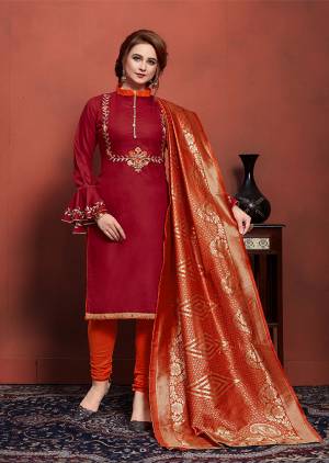 If Those Readymade Suit Does Not Lend You Desired Comfort, Than Grab This Designer Dress Material In Maroon Colored Top Paired With Contrasting Orange Colored Bottom and Dupatta. Get This Cotton Based Dress Material Stitched As Per Your Desired Fit And Comfort. Also Its Banarasi Art Silk Dupatta Gives  Highlight To All Over Look. 