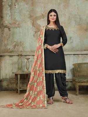 Grab This Very Beautiful And Attractive Looking Designer Suit In Black Color Paired With Peach Colored Dupatta. Its Top Is Fabricated On Satin Beautified With Embroidery Over Neckline, Paired With Santoon Fabricated Bottom And With Heavy Gota Work Chinon Fabricated Dupatta. The Main Highlight Of This Beautiful Suit Is Its Heavy Dupatta Which Has Gota Work. Buy This Suit Now.