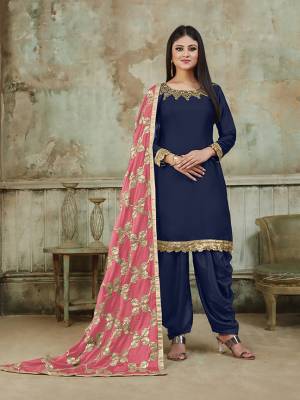 Grab This Very Beautiful And Attractive Looking Designer Suit In Navy Blue Color Paired With Pink Colored Dupatta. Its Top Is Fabricated On Satin Beautified With Embroidery Over Neckline, Paired With Santoon Fabricated Bottom And With Heavy Gota Work Chinon Fabricated Dupatta. The Main Highlight Of This Beautiful Suit Is Its Heavy Dupatta Which Has Gota Work. Buy This Suit Now.