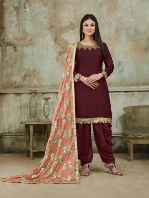 Grab This Very Beautiful And Attractive Looking Designer Suit In Maroon Color Paired With Peach Colored Dupatta. Its Top Is Fabricated On Satin Beautified With Embroidery Over Neckline, Paired With Santoon Fabricated Bottom And With Heavy Gota Work Chinon Fabricated Dupatta. The Main Highlight Of This Beautiful Suit Is Its Heavy Dupatta Which Has Gota Work. Buy This Suit Now.
