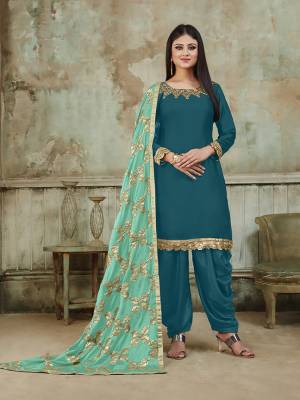 Grab This Very Beautiful And Attractive Looking Designer Suit In Blue Color Paired With Light Blue Colored Dupatta. Its Top Is Fabricated On Satin Beautified With Embroidery Over Neckline, Paired With Santoon Fabricated Bottom And With Heavy Gota Work Chinon Fabricated Dupatta. The Main Highlight Of This Beautiful Suit Is Its Heavy Dupatta Which Has Gota Work. Buy This Suit Now.