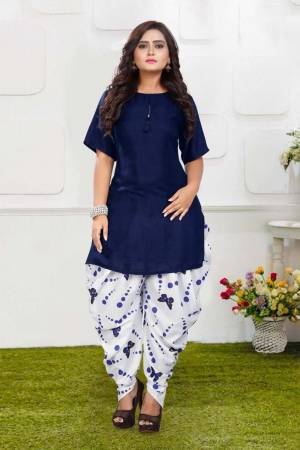 Grab This Pretty Pair Of Readymade Kurti And Dhoti In Navy Blue And White Color. This Kurti Is Fabricated On Rayon Slub Paired With Crepe Fabricated Digital Printed Dhoti. It Is Available In All Regular Sizes And Ensures superb Comfort All Day Long. Buy Now.