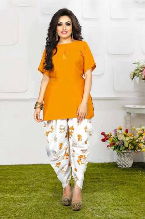 Grab This Pretty Pair Of Readymade Kurti And Dhoti In Musturd YellowAnd White Color. This Kurti Is Fabricated On Rayon Slub Paired With Crepe Fabricated Digital Printed Dhoti. It Is Available In All Regular Sizes And Ensures superb Comfort All Day Long. Buy Now.