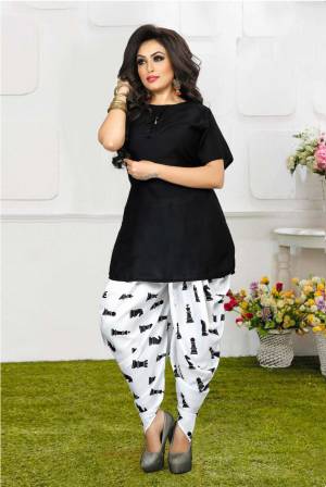 Grab This Pretty Pair Of Readymade Kurti And Dhoti In Black And White Color. This Kurti Is Fabricated On Rayon Slub Paired With Crepe Fabricated Digital Printed Dhoti. It Is Available In All Regular Sizes And Ensures superb Comfort All Day Long. Buy Now.