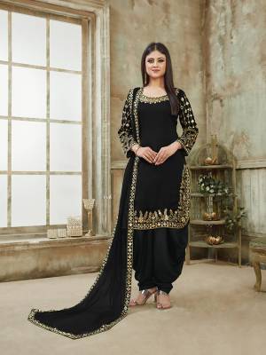 Here Is A Very Beautiful And Attractive Looking Heavy Designer Suit In All Over Black Color. Its Top Is Fabricated On Art Silk Paired With Santoon Bottom And Net Fabricated Dupatta. It Is Beautified With Heavy Jari Embroidery With Mirror Work. Buy Now.