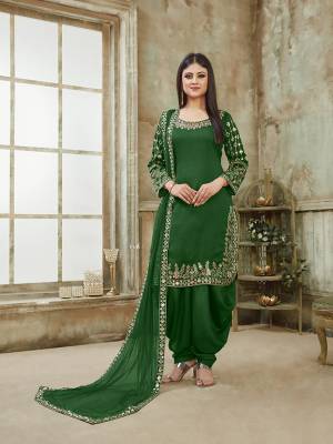 Here Is A Very Beautiful And Attractive Looking Heavy Designer Suit In All Over Green Color. Its Top Is Fabricated On Art Silk Paired With Santoon Bottom And Net Fabricated Dupatta. It Is Beautified With Heavy Jari Embroidery With Mirror Work. Buy Now.