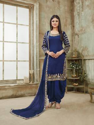 Here Is A Very Beautiful And Attractive Looking Heavy Designer Suit In All Over Royal Blue Color. Its Top Is Fabricated On Art Silk Paired With Santoon Bottom And Net Fabricated Dupatta. It Is Beautified With Heavy Jari Embroidery With Mirror Work. Buy Now.