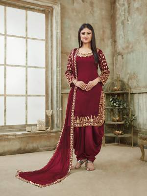 Here Is A Very Beautiful And Attractive Looking Heavy Designer Suit In All Over Maroon Color. Its Top Is Fabricated On Art Silk Paired With Santoon Bottom And Net Fabricated Dupatta. It Is Beautified With Heavy Jari Embroidery With Mirror Work. Buy Now.