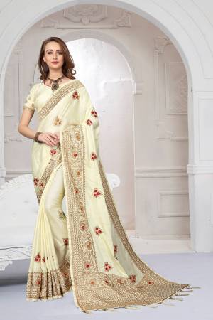 Rich And Elegant Looking Heavy But Subtle Look Designer Saree Is Here In Cream Color. This Pretty Embroidered Saree And Blouse are Fabricated On Satin Silk Beautified With Jari And Resham Work. Its Rich Fabric And Color Will Definitely Earn You Lots Of Compliments From Onlookers.