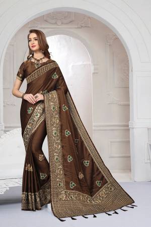 Rich And Elegant Looking Heavy But Subtle Look Designer Saree Is Here In Brown Color. This Pretty Embroidered Saree And Blouse are Fabricated On Satin Silk Beautified With Jari And Resham Work. Its Rich Fabric And Color Will Definitely Earn You Lots Of Compliments From Onlookers.