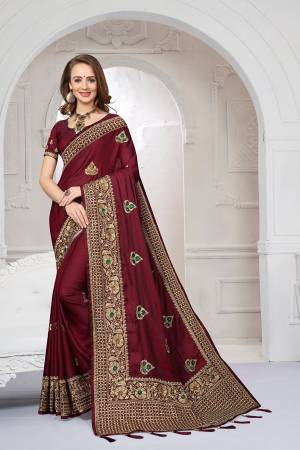 Rich And Elegant Looking Heavy But Subtle Look Designer Saree Is Here In Maroon Color. This Pretty Embroidered Saree And Blouse are Fabricated On Satin Silk Beautified With Jari And Resham Work. Its Rich Fabric And Color Will Definitely Earn You Lots Of Compliments From Onlookers.