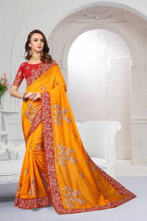 Get Ready For The Upcoming Festive And Wedding Season With This Heavy Designer Saree In Musturd Yellow Color Paired With Red Colored Blouse. This Saree Is Fabricated On Chiffon Satin Paired With Art Silk Fabricated Blouse. It Is Beautified With Attractive Embroidery With Heavy embroidered Lace Border. 