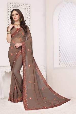 Simple And Elegant Looking Designer Saree With Attractive Kashmiri Work IS Here Light Brown Color. This Saree and Blouse are Georgette Based Beautified With Detailed Embroidery Giving It An Attractive Look. 