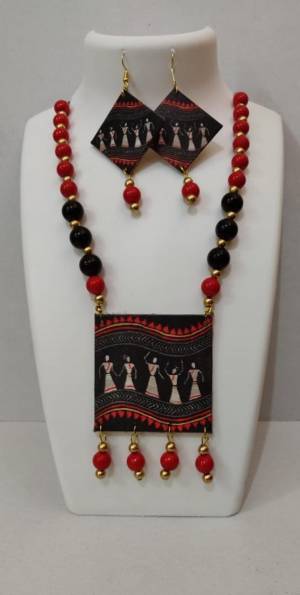 Grab This Unique Styled Necklace Set For This Navratri Festive In Multi Color. This Pretty Set Is Made Of Wood and Mix Metal Beautified With Prints And Bead Work. You Can Pair This Up With Any Contrasting Colored Attire. Buy Now.
